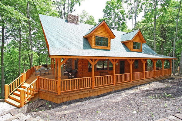 front of lodge, long wrap around porch, gravel driveway
