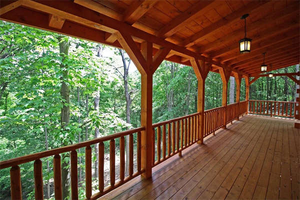 long wrap around porch, open area, wooded area