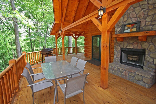 long wrap around porch, grill, fireplace, dining table