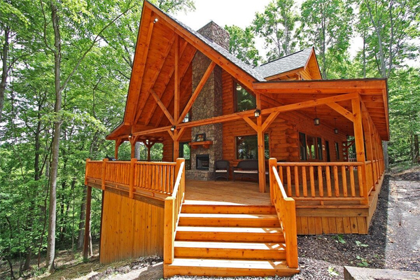 tall lodge, angle point roof, stairs leading up to deck