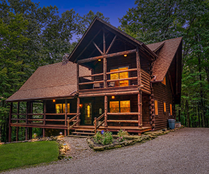 looking between 2 trees 2 two story lodge with open patio view