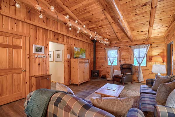 Spacious log cabin living room with panoramic views