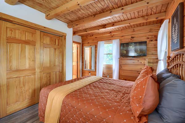 Rustic log cabin bedroom with wooden furniture