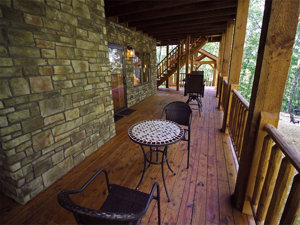 porch with seating, stone cabin wall