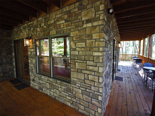 cabin exterior stone wall from wrap around porch