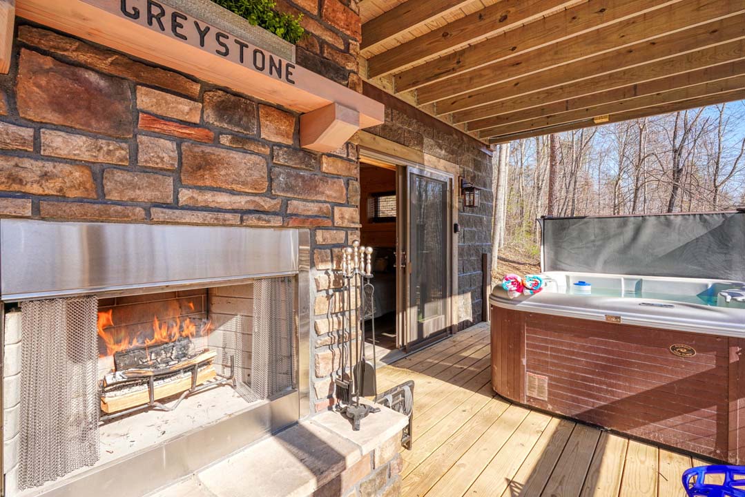 hot tub by fireplace on deck