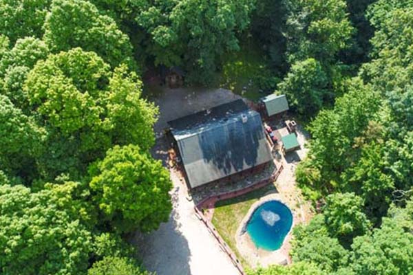 drone view of cabin with pool