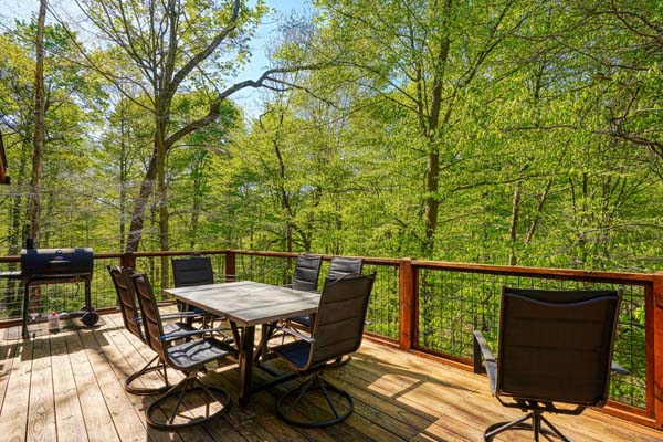 Serenity on the log cabin deck surrounded by wilderness