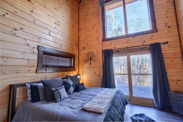 log cabin bedroom with large windows
