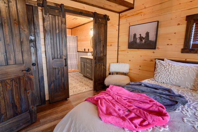 bedroom with barn doors to bathroom
