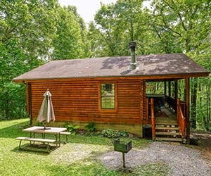side view of cabin with covered porch