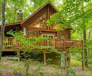 stone fireplace on front porch with side deck and jacuzzi