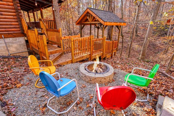yellow, blue, red and green chairs around firepit