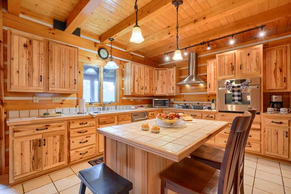 Rustic log cabin kitchen with wood beam ceiling