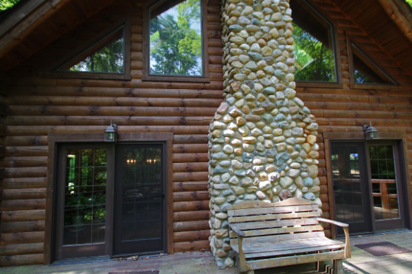 stone fireplace outside cabin
