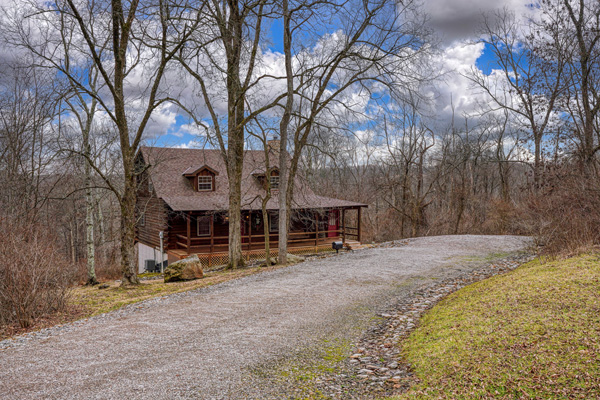 cabin with gravel driveway