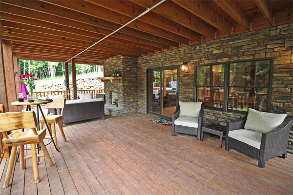 covered deck with patio doors to cabin