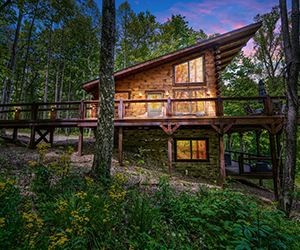 cabin in woods, deck, wrap around porch