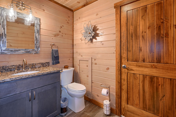 Woodsy ambiance in the log cabin bathroom