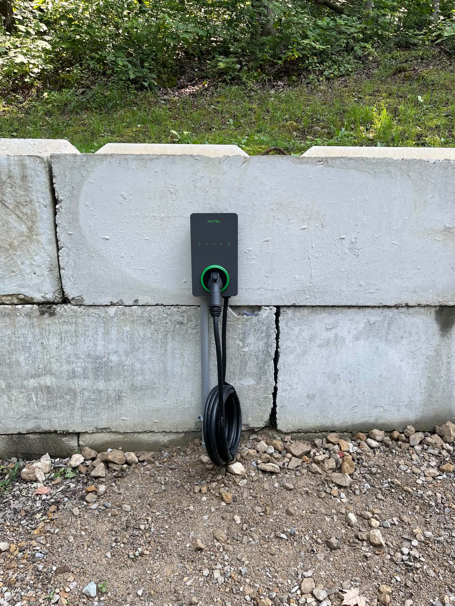 EV charging station at The Tradesman — wall-mounted Autel charger beside the parking area